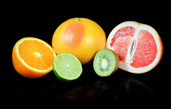 Oranges, kiwi, lime, black background, grapefruit