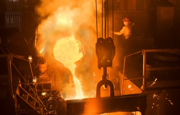 Fire, heat, sparks, molten metal, smelting factory worker