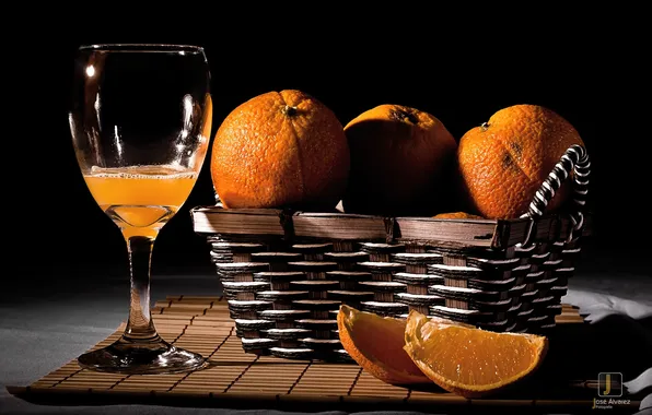 Picture the dark background, glass, oranges, juice, basket, citrus, slices