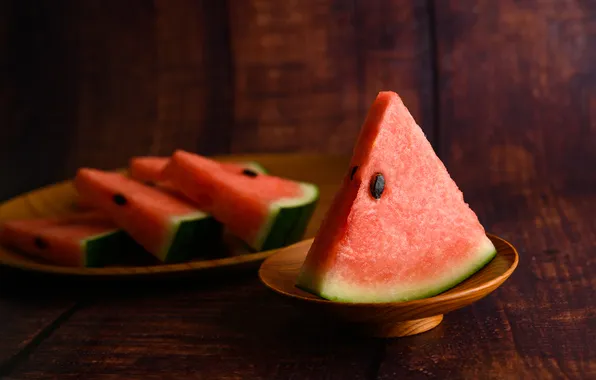 The dark background, table, Board, watermelon, plate, slices, saucer, bokeh