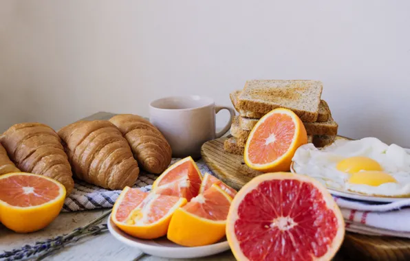 Eggs, citrus, tablecloth, croissants