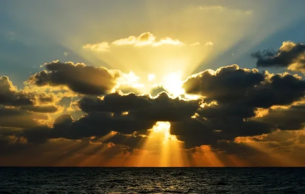 Picture the sun, clouds, rays, the ocean