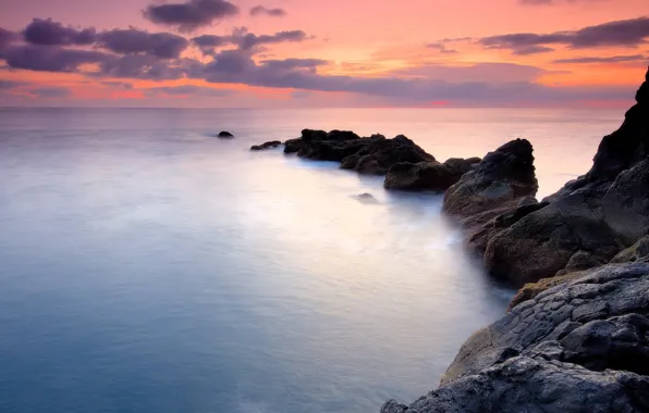 The sky, water, sunset, the ocean, rocks