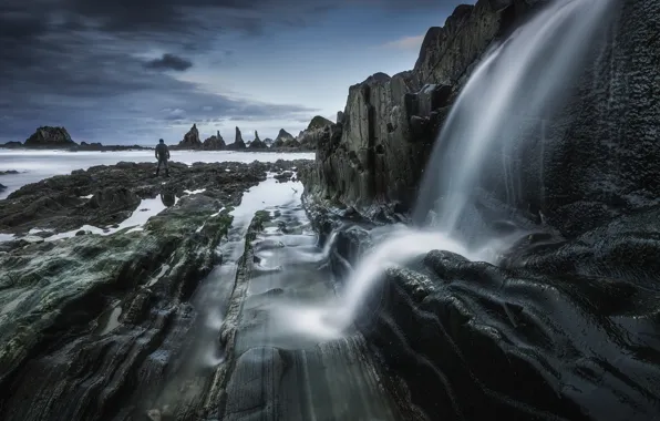 Sea, stones, overcast, the ocean, rocks, shore, people, waterfall