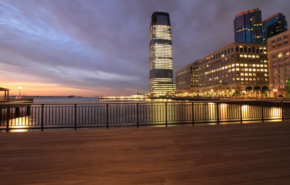 The sky, clouds, sunset, orange, clouds, lights, river, skyscrapers