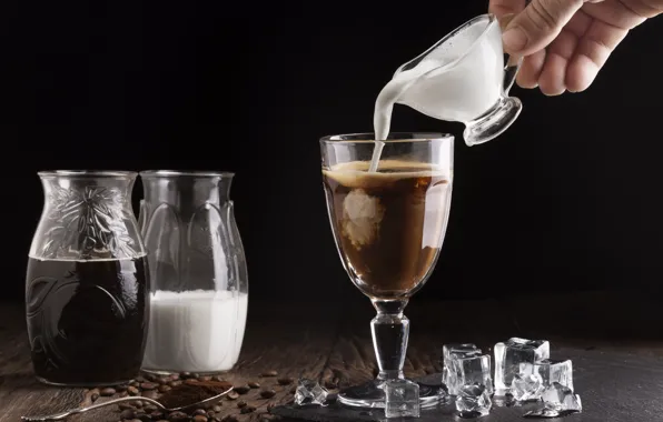 Glass, coffee, hand, ice, milk, spoon, banks, black background