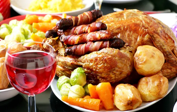 Vegetables, carrots, festive table, a glass of wine, potatoes, garnish, fried chicken, sausages