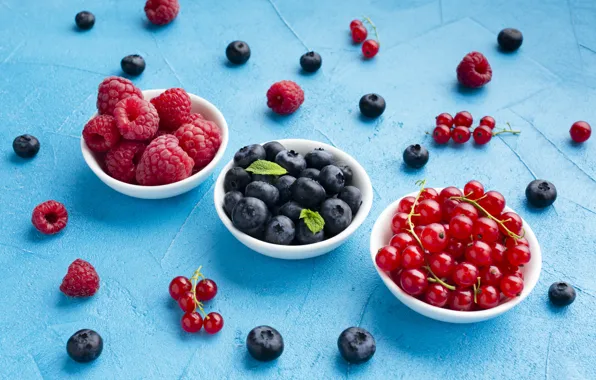 Berries, blue background, bowls