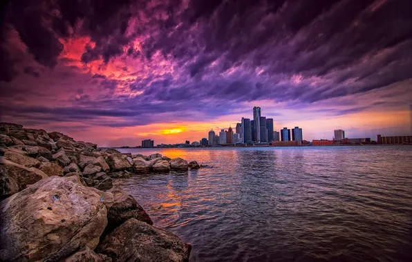 Picture the sky, clouds, sunset, the city, river, stones, building, skyscrapers
