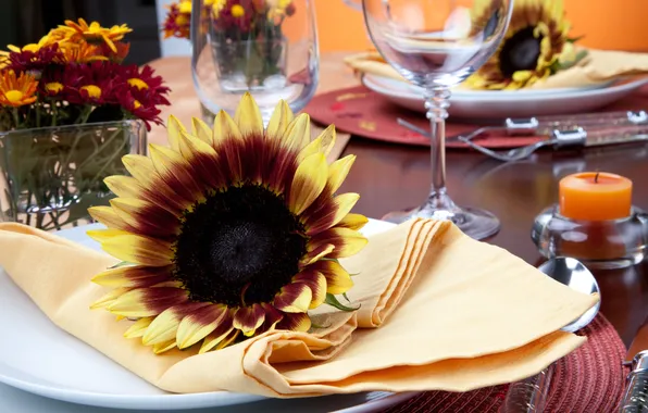 Picture sunflowers, flowers, table, candles, glasses, plates, knives, fork