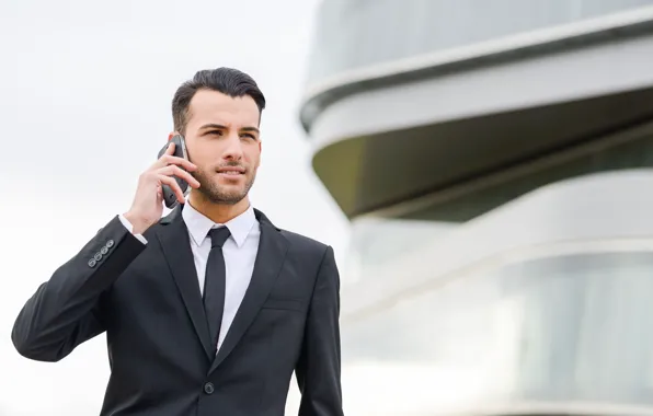 Picture the building, phone, guy, young, businessman, negotiations