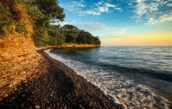 The sky, the sun, clouds, trees, lake, stones, shore, horizon