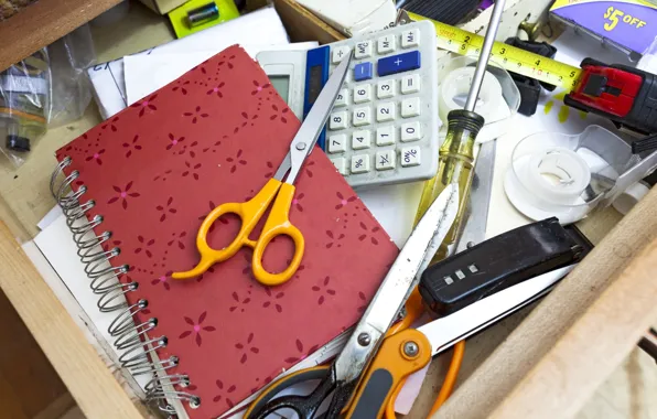 Scissors, screwdriver, calculator, drawer, clutter