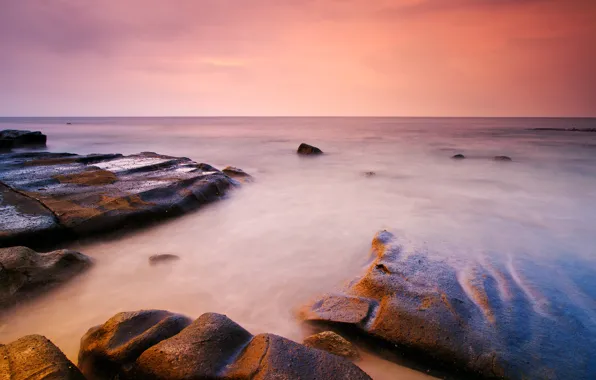 Stones, the ocean, dawn, horizon