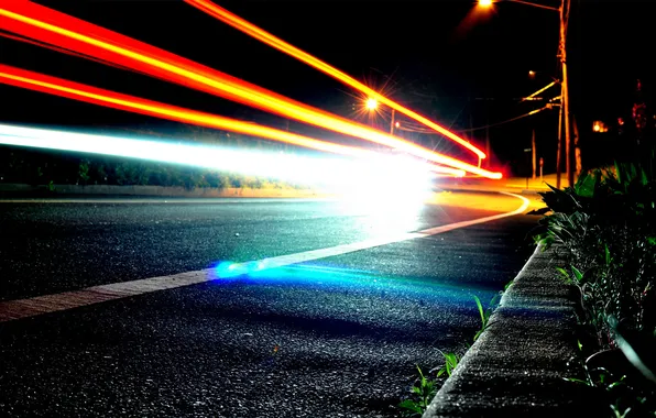 Road, lights, lights, the trail from the headlights