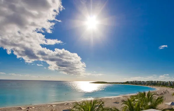 Sea, the sky, the sun, clouds, rays, palm trees, shore