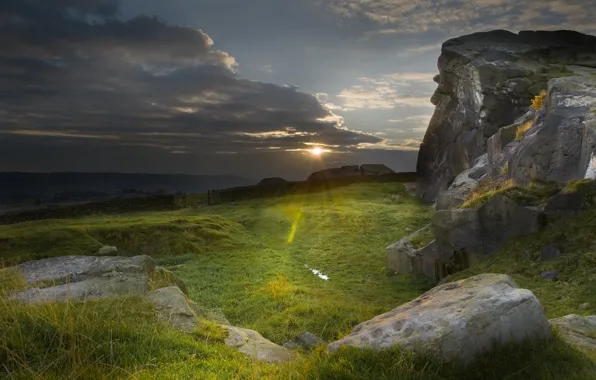 Picture the sky, grass, rays, mountains, clouds, rocks