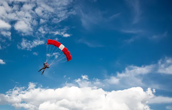 Picture the sky, the sun, clouds, sport, parachute, costume, athlete, skydiving
