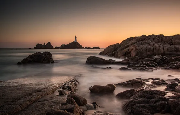 Sea, the sky, rocks, lighthouse, the evening, tide