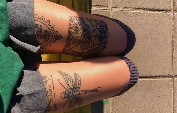 Girl, black dress, leg warmers, slender legs, tattoos on the legs, tanned legs