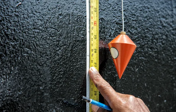 Picture wall, tape measure, plumb
