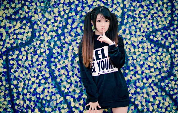 Picture the sign of silence, Oriental girl, finger