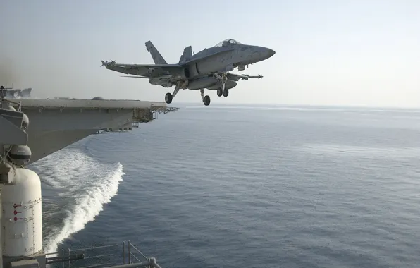 F/A-18, American carrier-based fighter-bomber and attack aircraft, taking off from the deck of an aircraft …