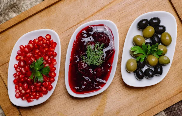 Plates, olives, olives, pomegranate grains, canned vegetables