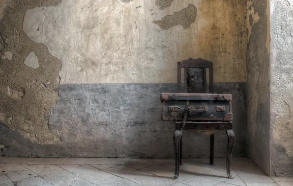 Wall, chair, suitcase