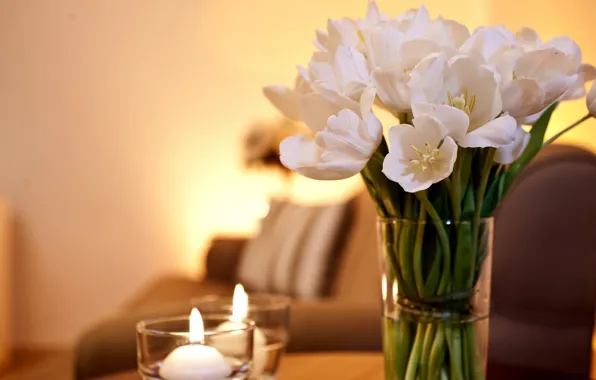 Candles, on the table, white tulips, in a vase