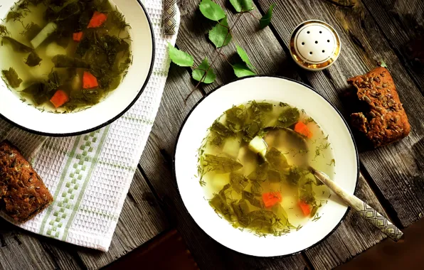 Bread, spoon, soup, plates, vegetables, salt shaker