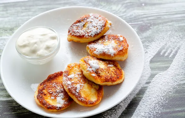 Table, trail, plate, plug, powdered sugar, sour cream, pancakes