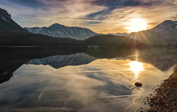 The sun, mountains, lake