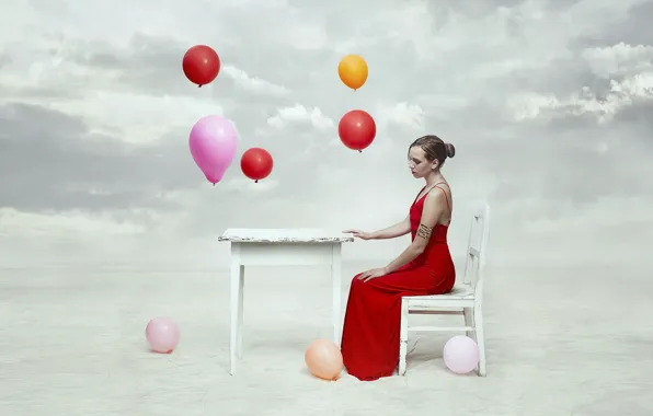 The sky, girl, table, balls, chair