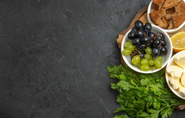 The dark background, grapes, parsley