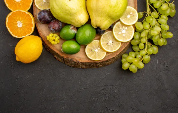 Oranges, grapes, grey background, lemons, quince