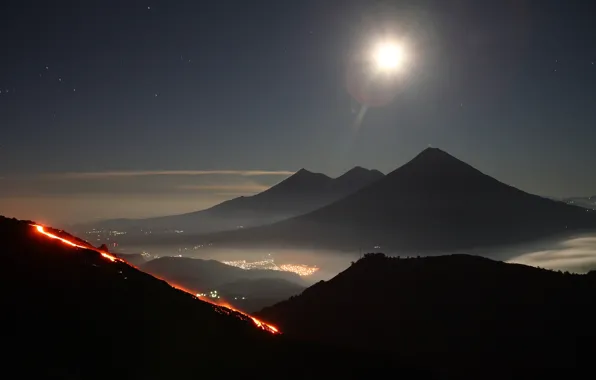 Picture the sky, stars, mountains, the city, lights, the volcano, the eruption, Guatemala