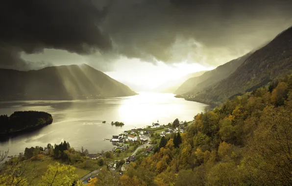 The sun, clouds, trees, mountains, river, street, storm, village