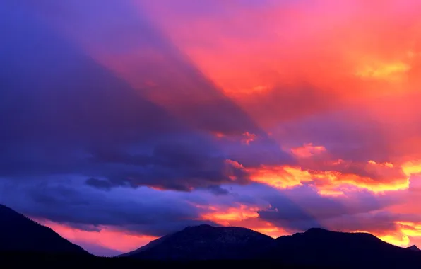 The sky, clouds, rays, sunset, mountains, color, glow