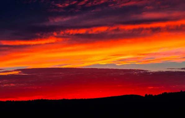 The sky, clouds, sunset, hills, horizon, glow