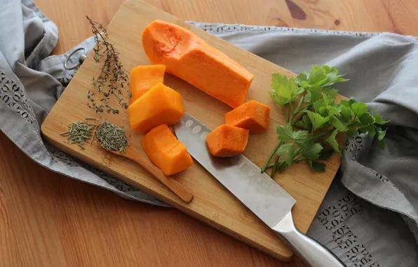 Table, towel, spoon, knife, pumpkin, pieces, parsley, slices