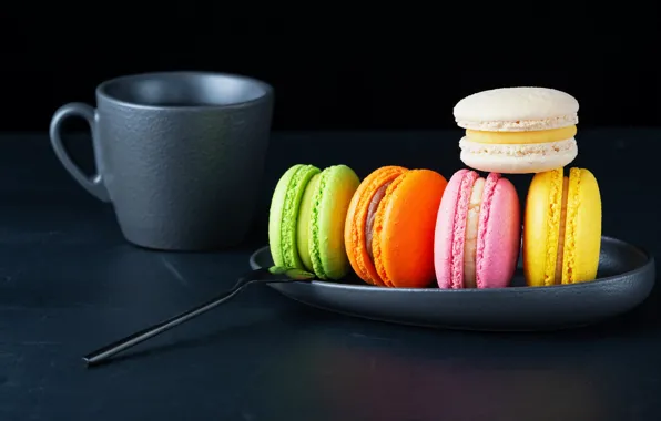 The dark background, table, colored, cookies, plate, spoon, mug, cake