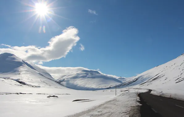 Road, the sun, snow, hills