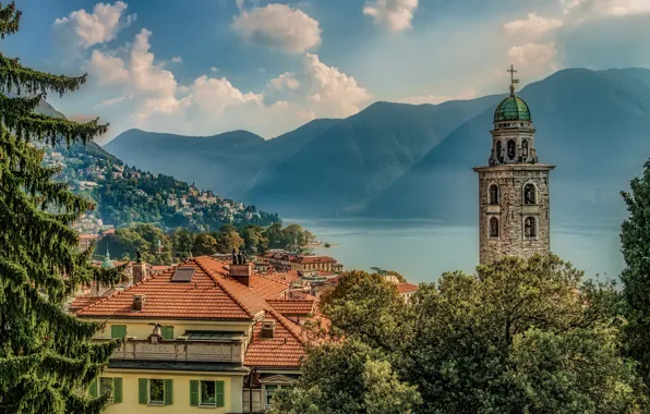 The sky, the sun, clouds, trees, mountains, lake, tower, home