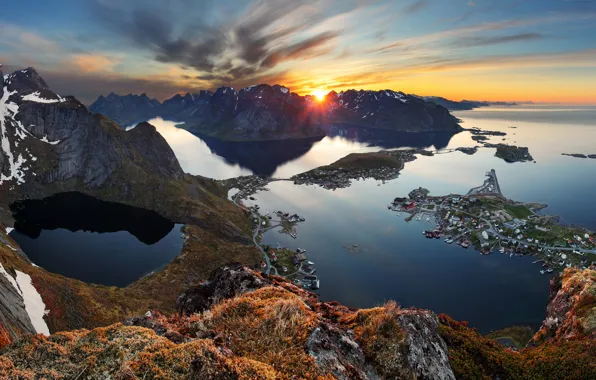 Sea, the sky, the sun, clouds, rays, mountains, rocks, dawn