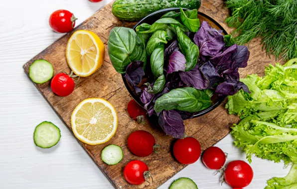 Picture greens, lemon, vegetables, cucumbers, tomatoes