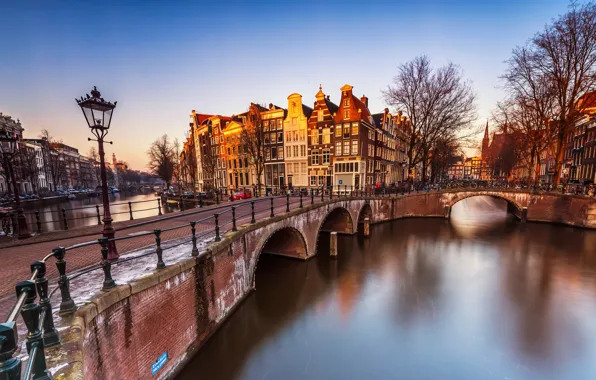 The sky, light, trees, landscape, bridge, river, people, street