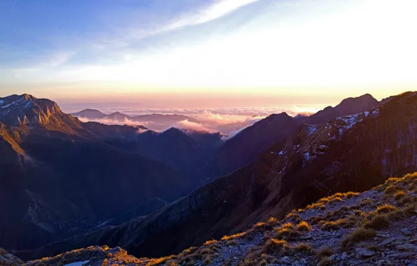 Picture the sky, grass, clouds, snow, trees, sunset, mountains, stones