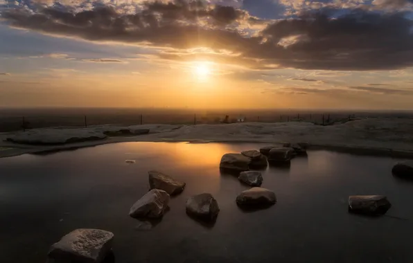 Picture the sky, the sun, clouds, sunset, stones, shore, horizon, pond
