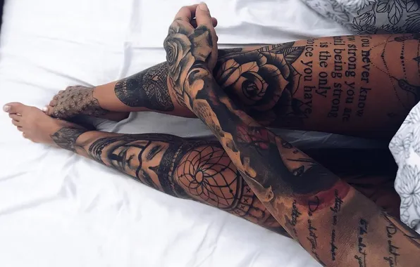 Manicure, tattoo on the hand, tattoo on feet, slender legs